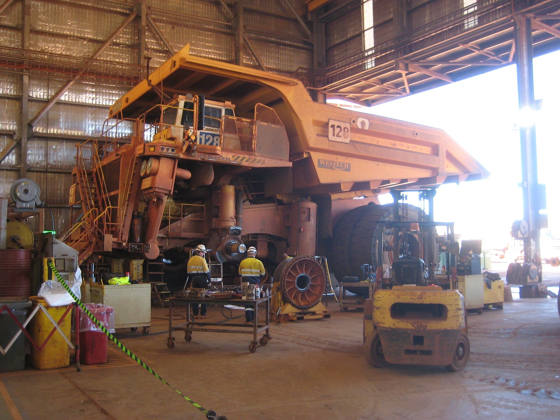 Maintenance crew working on a haul truck wheel motor inside the heavy vehicle workshop at the Brockman 4 mine.